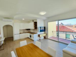 a kitchen and living room with a table and chairs at Attico Da Vinci Luxury Penthouse in Olbia