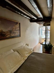 ヴェネツィアにあるResidenza Canaletto Veneziaのベッドと壁に絵が飾られた寝室