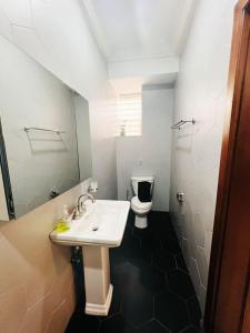 a bathroom with a sink and a toilet at Brew Homes At Elsie Apartment in Accra +23 photos