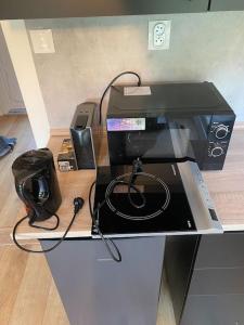 a desk with a printer and a phone on it at Tiny house & AC in Banská Štiavnica +4 photos