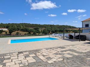 a swimming pool on the roof of a house at CASA MOSTEIROS in Viegas