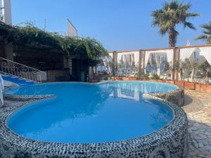 a large blue swimming pool in a resort at Sea Breeze Apartment Bougainville Bay in Sarandë