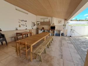 a large room with a wooden table and a kitchen at CASA MOSTEIROS in Viegas