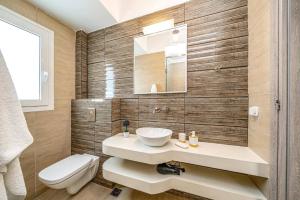 a bathroom with a sink and a toilet at Villa Ble by Villa Plus in Plateies +19 photos