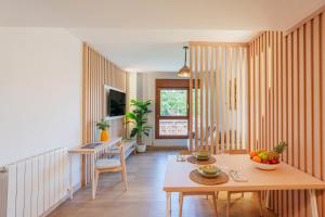 a living room with a table with a bowl of fruit on it at Spirit Apartamentos Atxuri in Bilbao