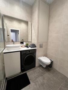 a bathroom with a sink and a toilet in it at Апартаменты ЖК АТАМЕКЕН in Karagandy