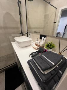a bathroom with a sink and towels on a counter at Апартаменты ЖК АТАМЕКЕН in Karagandy