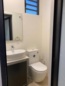 a bathroom with a white toilet and a sink at Luxnar FF Wave in La Gaulette