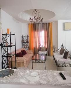 a living room with a couch and a table at Joli appartement vue sur la mer in Sousse