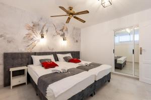 a bedroom with a large bed with a ceiling fan at Los Geranios 307 in Adeje +29 photos