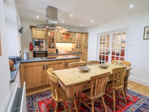 a large kitchen with a wooden table and chairs at Rowan Cottage in Grasmere