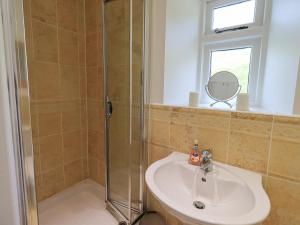 a bathroom with a shower and a sink at Rowan Cottage in Grasmere +30 photos