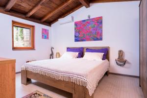 a bedroom with a bed and a painting on the wall at Spacious House with Private Pool in Stari Grad in Stari Grad +68 photos