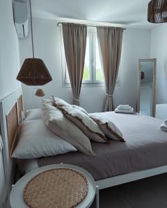a bedroom with two beds with pillows and a window at SaDomoSicula UJazzu in Ragusa