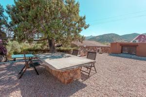 a picnic table and a bench in a yard at B&B Pettirosso Garden in San Teodoro