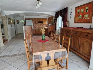 a kitchen with a wooden table with a vase on it at Villa Sambracitaine in Les Issambres