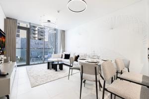 a dining room with a table and chairs at Exclusive 1BR District 1 - Crystal Lagoon Access in Dubai