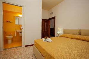 een hotelkamer met twee bedden en een badkamer bij Acquamarina in Grottammare