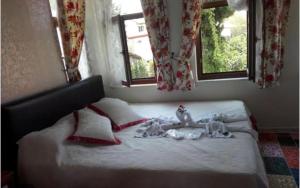 two dolls laying on a bed in a bedroom at Velespit Hotel in Antalya