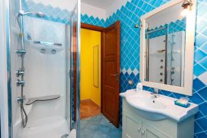 a bathroom with a sink and a shower at B&B Pettirosso Garden in San Teodoro +40 photos