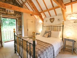 a bedroom with a bed in a room at Stable Cottage in Newport Pembrokeshire