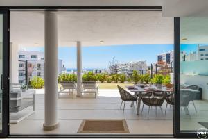 a view from the balcony of a house with a table and chairs at ViVi Homes - El Valle Pool & Sea View in Fuengirola