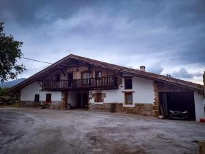 a house with a balcony on the side of it at Okana Baserria in Muxika