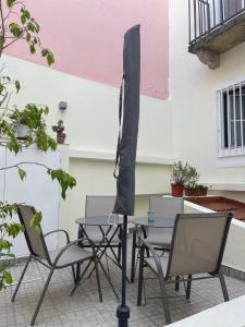 a table and chairs and an umbrella on a patio at Bairro Alto - Apartamento in Lisbon +21 photos