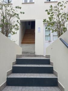 a set of stairs leading to a white house at Bairro Alto - Apartamento in Lisbon