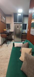 un soggiorno con divano verde e frigorifero di Nuevo Apartamento de 1 dormitorio, cerca de Equipetrol amoblado con Internet y Parqueo bajo techo a Santa Cruz de la Sierra