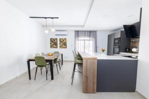 a kitchen and dining room with a table and chairs at Luxury Family Apartment close to Mgarr ix-Xini with Parking in Xewkija +25 photos