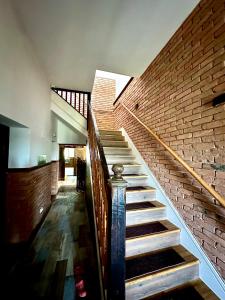 a staircase in a building with a brick wall at MARADA felix in Hidişelul-de Sus