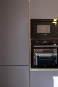 a microwave oven sitting next to a refrigerator at Luxury Family Apartment close to Mgarr ix-Xini with Parking in Xewkija