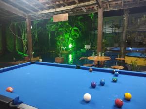 a pool table in a room with two pools at Pousada Atobá Juquehy Apartamentos in Juquei
