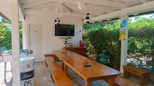 a room with a table and a tv on the wall at Residenza Pousada Romantica in Tropea
