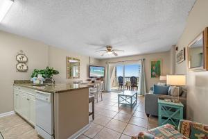 a kitchen and living room with a view of the ocean at Tradewinds 307 in Orange Beach