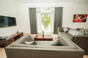 a living room with a couch and a table at Shelter Beach Resort in Mahabalipuram
