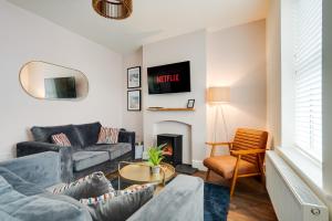 a living room with a couch and a fireplace at The Tides, 3 bed house Morecambe in Morecambe
