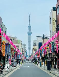 a city street with a view of the eiffel tower at Kita-Ueno Inn - Near UENO, ASAKUSA, SENSOJI, TOKYO SKY TREE - Self check-in in Tokyo