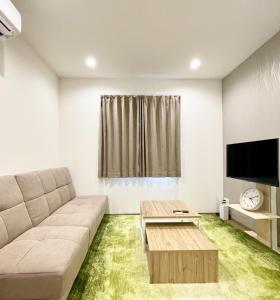a living room with a couch and a table at Kita-Ueno Inn - Near UENO, ASAKUSA, SENSOJI, TOKYO SKY TREE - Self check-in in Tokyo