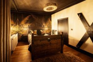 a bedroom with a bed and a wall with plants at Casa Amor - Adult Only Retreat Midlands in Stoke on Trent