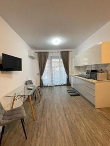 a living room with a table and a kitchen at Best View luxury in Costinesti