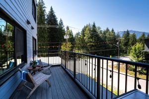 a balcony of a house with a bench on it at Hemlock Hangout by Revelstoke Vacations in Revelstoke