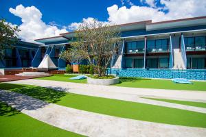 A garden outside The Phu Beach Hotel - SHA Plus