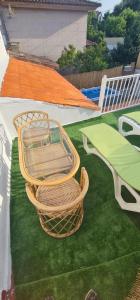 two wicker chairs sitting on top of a roof at Casa Independiente en Quintela - HomeyGalicia in Vigo