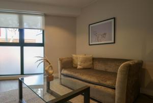 a living room with a couch and a glass table at 1BR near Central Restaurant in Barranco by Wynwood House in Lima