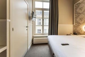 Postel nebo postele na pokoji v ubytování Hotel karel de stoute