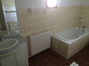 un bagno con vasca e lavandino di Villa spacieuse avec piscine à Rocher 180 m² 10 pers. a Rocher Altre 17 foto