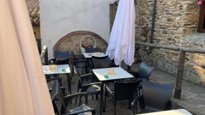 a row of tables and chairs on a patio at Hosteria La Higuera H-CC-798 in Garrovillas +16 photos