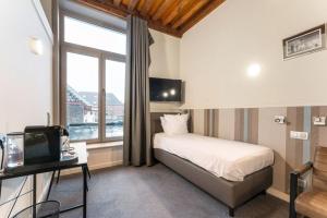 Postel nebo postele na pokoji v ubytování Hotel karel de stoute